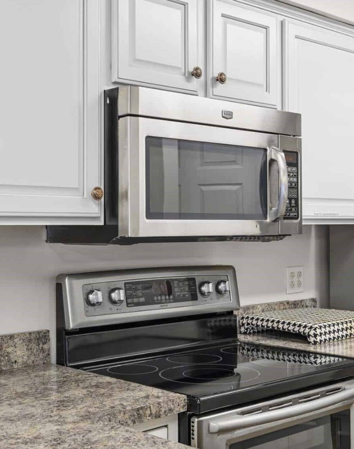 a kitchen with white cabinets